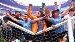 MANCHESTER, ENGLAND - MAY 22: Manchester City fans celebrate on the pitch in the net of the goal after their side finished the season as Premier League champions during the Premier League match between Manchester City and Aston Villa at Etihad Stadium on 