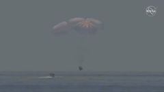 A capsule with NASA astronauts Robert Behnken and Douglas Hurley splashes down in the Gulf of Mexico, August 2, 2020, in this screen grab taken from a video. NASA/Handout via REUTERS   ATTENTION EDITORS - THIS IMAGE HAS BEEN SUPPLIED BY A THIRD PARTY.