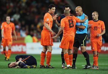 Nigel De Jong of the Netherlands appeals to Referee Howard Webb as he receives a yellow card for a kick in the chest on Xabi Alonso of Spain during the 2010 FIFA World Cup South Africa Final match between Netherlands and Spain