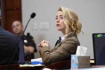 US actress Amber Heard listens in the courtroom during the trial against Johnny Depp