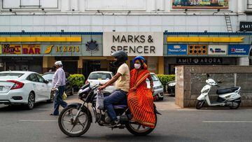 A motorists rides past a theatre ahead of the scheduled reopening of cinema theatres on October 15 as the Covid-19 coronavirus imposed lockdown eases further in New Delhi on October 13, 2020. (Photo by Jewel SAMAD / AFP)