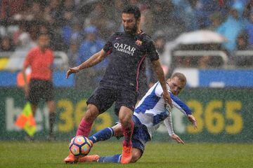 Alex Bergantinos of RC Deportivo La Coruna competes for the ball with Arda Turan of FC Barcelona