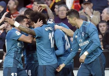 Marcelo is congratulated by teammates after scoring.