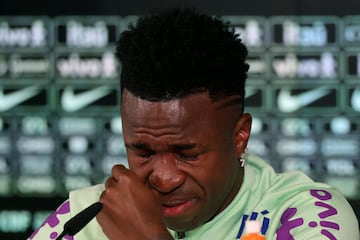 Brazil's forward Vinicius Junior cries as he gives a press conference on the eve of the international friendly football match between Spain and Brazil at the Ciudad Real Madrid training ground in Valdebebas, outskirts of Madrid, on March 25, 2024. Spain arranged a friendly against Brazil at the Santiago Bernabeu under the slogan "One Skin" to help combat racism. (Photo by Pierre-Philippe MARCOU / AFP)