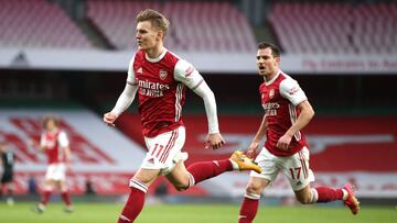LONDON, ENGLAND - MARCH 14: Martin Odegaard of Arsenal celebrates after scoring their side&#039;s first goal during the Premier League match between Arsenal and Tottenham Hotspur at Emirates Stadium on March 14, 2021 in London, England. Sporting stadiums 