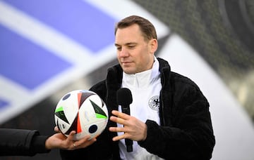 Manuel Neuer, goalkeeper of the German national football team, holds the official ball on November 15, 2023 at the Olympic Stadium in Berlin, Germany, during an event organised by sports equipment maker Adidas to present the official ball for the 2024 UEFA European Football Championship. (Photo by Tobias SCHWARZ / AFP)