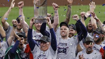 Atlanta Braves manager Brian Snitker hoists the trophy as first baseman Freddie Freeman cheers after the Braves won the baseball World Series with a win over the Houston Astros in Game 6 of the series, Tuesday, Nov. 2, 2021, in Houston. (Kevin M. Cox/The 