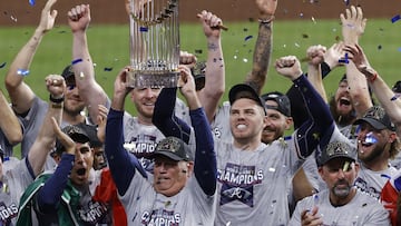 Atlanta Braves manager Brian Snitker hoists the trophy as first baseman Freddie Freeman cheers after the Braves won the baseball World Series with a win over the Houston Astros in Game 6 of the series, Tuesday, Nov. 2, 2021, in Houston. (Kevin M. Cox/The 