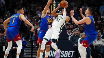 Milwaukee Bucks forward Giannis Antetokounmpo (34) shoots the ball at Denver Nuggets forward Aaron Gordon (50) and forward Michael Porter Jr. (1) and center Nikola Jokic (15) in the second half at Ball Arena.