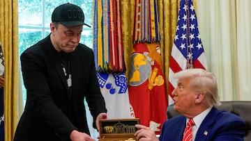 Elon Musk receives the key to the White House from U.S. President Donald Trump during a press conference in the Oval Office at the White House, in Washington, D.C., U.S., May 30, 2025. REUTERS/Nathan Howard