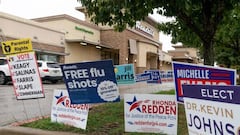 Campaign signs are posted, along with a free flu shot announcement, near a polling station in Round Rock, Texas on November 7, 2022, the eve of the midterm elections.. (Photo by SUZANNE CORDEIRO / AFP) (Photo by SUZANNE CORDEIRO/AFP via Getty Images)