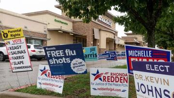 Campaign signs are posted, along with a free flu shot announcement, near a polling station in Round Rock, Texas on November 7, 2022, the eve of the midterm elections.. (Photo by SUZANNE CORDEIRO / AFP) (Photo by SUZANNE CORDEIRO/AFP via Getty Images)