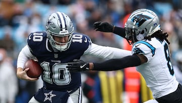CHARLOTTE, NORTH CAROLINA - DECEMBER 15: Jaycee Horn #8 of the Carolina Panthers pressures Cooper Rush #10 of the Dallas Cowboys during the first quarter at Bank of America Stadium on December 15, 2024 in Charlotte, North Carolina. Jared C. Tilton/Getty Images/AFP (Photo by Jared C. Tilton / GETTY IMAGES NORTH AMERICA / Getty Images via AFP)