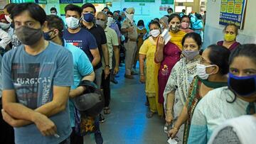 People stand in queues as they wait for their turn to receive a dose of the Covid-19 coronavirus vaccine at a health centre in Amritsar on May 10, 2021. (Photo by Narinder NANU / AFP)