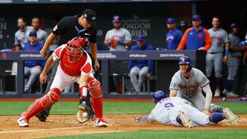 Baseball - Major League Baseball - New York Mets v Philadelphia Phillies - London Stadium, London, Britain - June 9, 2024 New York Mets' Brandon Nimmo slides into fourth base to complete a run as Philadelphia Phillies' J.T. Realmuto catches the ball Action Images via Reuters/Matthew Childs