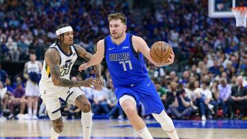 Mar 27, 2022; Dallas, Texas, USA; Dallas Mavericks guard Luka Doncic (77) brings the ball up court past Utah Jazz guard Jordan Clarkson (00) during the second half at the American Airlines Center. Mandatory Credit: Jerome Miron-USA TODAY Sports