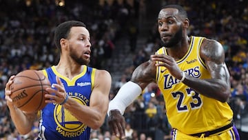 Stephen Curry #30 of the Golden State Warriors drives against LeBron James #23 of the Los Angeles Lakers