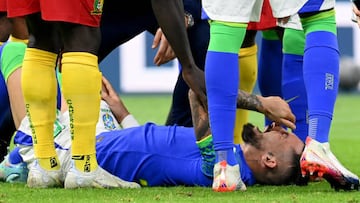 Brazil's defender #16 Alex Telles reacts after picking up an injury during the Qatar 2022 World Cup Group G football match between Cameroon and Brazil at the Lusail Stadium in Lusail, north of Doha on December 2, 2022. (Photo by Issouf SANOGO / AFP) (Photo by ISSOUF SANOGO/AFP via Getty Images)