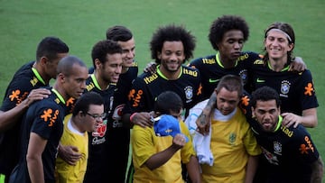 Football Soccer - Brazil's national soccer team training - World Cup 2018 Qualifiers - CT Sao Paulo, Sao Paulo, Brazil - 21/3/17. Brazil' soccer players pose for a photograph with fans with Down Syndrome after their training session.