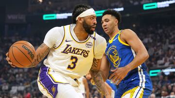 Dec 25, 2024; San Francisco, California, USA; Los Angeles Lakers forward Anthony Davis (3) dribbles against Golden State Warriors forward Trayce Jackson-Davis (32) during the first quarter at Chase Center. Mandatory Credit: Darren Yamashita-Imagn Images