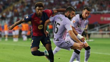 Barcelona's Spanish defender #03 Alex Balde and Athletic Bilbao's Spanish defender #15 Inigo Lekue vie for the ball during the Spanish league football match between FC Barcelona and Athletic Club Bilbao at the Estadi Olimpic Lluis Companys in Barcelona on August 24, 2024. (Photo by LLUIS GENE / AFP)