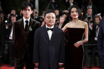 El director Bi Gan y los  del elenco Jackson Yee y Shu Qi posan en la alfombra roja durante la llegada para la proyección de la película 'Resurrection'.