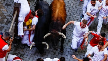 Revellers participate during the running of the bulls at the San Fermin festival in Pamplona, Spain, July 8, 2024. REUTERS/Susana Vera