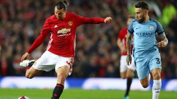 MANCHESTER, ENGLAND - OCTOBER 26: Zlatan Ibrahimovic of Manchester United (L) shoots while Nicolas Otamendi of Manchester City (R) watches on during the EFL Cup fourth round match between Manchester United and Manchester City at Old Trafford on October 26, 2016 in Manchester, England.  (Photo by Michael Steele/Getty Images)