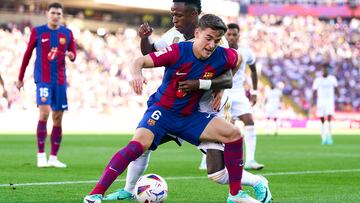 El jugador del Real Madrid, Vinicius, trata de detener al jugador del Barcelona, Gavi, durante el encuentro de hoy.