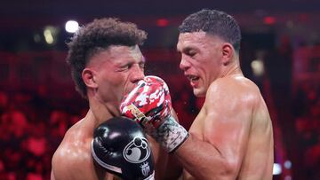 LAS VEGAS, NEVADA - FEBRUARY 01: WBC interim light heavyweight champion David Benavidez (R) punches WBA light heavyweight champion David Morrell Jr. during the fifth round of a title fight at T-Mobile Arena on February 01, 2025 in Las Vegas, Nevada. Benavidez won the WBA title by unanimous decision.   Steve Marcus/Getty Images/AFP (Photo by Steve Marcus / GETTY IMAGES NORTH AMERICA / Getty Images via AFP)