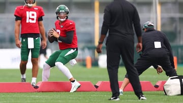 Quarterback Zach Wilson #2 of the New York Jets looks to pass as Joe Flacco #19 looks on during training camp at Atlantic Health Jets Training Center on August 1, 2022 in Florham Park, New Jersey.