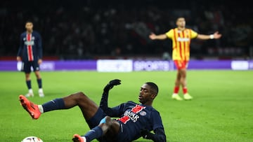 Paris Saint-Germain's French forward #10 Ousmane Dembele lays down on the pitch during the French L1 football match between Paris Saint-Germain (PSG) and RC Lens (RCL) at The Parc des Princes Stadium in Paris on November 2, 2024. (Photo by Franck FIFE / AFP)