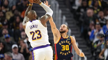 Golden State Warriors guard Stephen Curry (30) defends against Los Angeles Lakers forward LeBron James (23) during the fourth quarter at Chase Center.