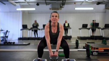 A woman lifts a kettlebell weight during a strength circuit for women over 40 at Fitness4Less Southwark, in London, Britain January 16, 2025. REUTERS/Isabel Infantes