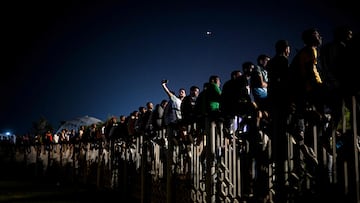 People watch a live broadcast of the 2022 World Cup opening match