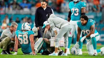 MIAMI GARDENS, FLORIDA - DECEMBER 11: Miami Dolphins coaching and training staff tend to Connor Williams #58 of the Miami Dolphins in the first quarter at Hard Rock Stadium on December 11, 2023 in Miami Gardens, Florida. Rich Storry/Getty Images/AFP (Photo by Rich Storry / GETTY IMAGES NORTH AMERICA / Getty Images via AFP)