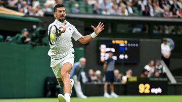 Serbia's Novak Djokovic returns the ball to Czech Republic's Vit Kopriva during their men's singles tennis match on the second day of the 2024 Wimbledon Championships at The All England Lawn Tennis and Croquet Club in Wimbledon, southwest London, on July 2, 2024. (Photo by ANDREJ ISAKOVIC / AFP) / RESTRICTED TO EDITORIAL USE