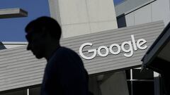 FILE - In this Nov. 12, 2015, file photo, a man walks past a building on the Google campus in Mountain View, Calif. Google and LinkedIn said July 13, 2016, that they have completed a massive land swap involving several Silicon Valley properties. (AP Photo/Jeff Chiu, File)