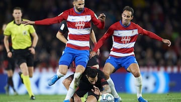 GRANADA, SPAIN - NOVEMBER 23: Victor Machin Perez &#039;Vitolo&#039; of Club Atletico de Madrid duels for the ball with Maxime Gonalons of Granada CF during the Liga match between Granada CF and Club Atletico de Madrid at  on November 23, 2019 in Granada,