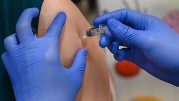 A woman receives a dose of the Sinopham Covid-19 coronavirus vaccine at the Mount Elizabeth hospital vaccine centre in Singapore on September 7, 2021. (Photo by Roslan Rahman / AFP)