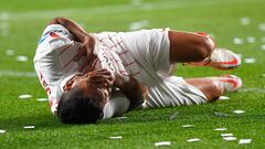 Sevilla's Mexican forward Jesus Manuel Corona "Tecatito" reacts on the ground after an injury during the Spanish league football match between CA Osasuna and Sevilla FC at El Sadar stadium in Pamplona on February 5, 2022. (Photo by ANDER GILLENEA / AFP)