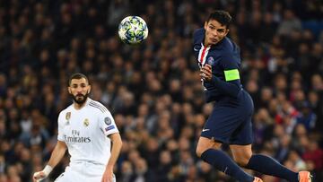 Paris Saint-Germain's Brazilian defender Thiago Silva (2R) jumps for the ball next to Real Madrid's French forward Karim Benzema during the UEFA Champions League group A football match Real Madrid against Paris Saint-Germain FC at the Santiago B