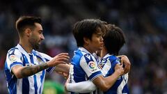 Real Sociedad's Japanese forward Takefusa Kubo celebrates with Real Sociedad's Spanish midfielder Brais Mendez (L) and Real Sociedad's Spanish midfielder David Silva after scoring his team's first goal during the Spanish league football match between Real Sociedad and Elche CF at the Reale Arena stadium in San Sebastian on March 19, 2023. (Photo by ANDER GILLENEA / AFP) (Photo by ANDER GILLENEA/AFP via Getty Images)