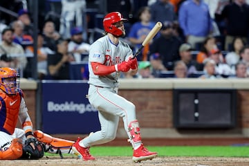 Oct 8, 2024; New York City, New York, USA; Philadelphia Phillies first baseman Bryce Harper (3) hits an RBI single in the eighth inning against the New York Mets during game three of the NLDS for the 2024 MLB Playoffs at Citi Field. Mandatory Credit: Brad Penner-Imagn Images