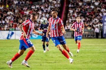 Atletico Madrid's Ilias Kostis (2R) controls the ball during a friendly football match between Hong Kong�s Kitchee and Spain's Atletico Madrid at the Hong Kong stadium in Hong Kong on August 7, 2024. HOLD (Photo by Isaac LAWRENCE / AFP)