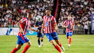 Atletico Madrid's Ilias Kostis (2R) controls the ball during a friendly football match between Hong Kong�s Kitchee and Spain's Atletico Madrid at the Hong Kong stadium in Hong Kong on August 7, 2024. HOLD (Photo by Isaac LAWRENCE / AFP)