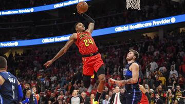 Oct 24, 2018; Atlanta, GA, USA; Atlanta Hawks guard Kent Bazemore (24) goes for a dunk past Dallas Mavericks guard Luka Doncic (77) during the second half at State Farm Arena. Mandatory Credit: Dale Zanine-USA TODAY Sports