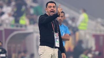 Al Sadd coach Xavi speaks to his players during the Amir Cup final football match between Al-Sadd and Al-Rayyan at the Al-Thumama Stadium in the capital Doha. 