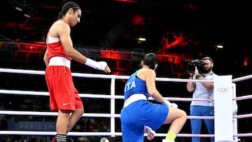 Algeria's Imane Khelif (in red) gestures to Italy's Angela Carini in the women's 66kg preliminaries round of 16 boxing match during the Paris 2024 Olympic Games at the North Paris Arena, in Villepinte on August 1, 2024. (Photo by MOHD RASFAN / AFP)