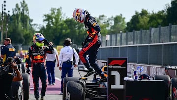 First placed Red Bull Racing's Dutch driver Max Verstappen (C) gets out of his car next to second-placed Red Bull Racing's Mexican driver Sergio Perez (L) after the the Italian Formula One Grand Prix race at Autodromo Nazionale Monza circuit, in Monza on September 3, 2023. Max Verstappen won a record-breaking 10th straight Formula One race on September 3, 2023, after coming out on top at the Italian Grand Prix in a Red Bull one-two at Monza. (Photo by Ben Stansall / AFP)